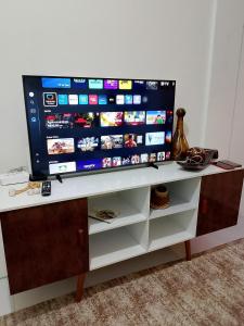a flat screen tv sitting on top of a tv stand at Apto Beira Mar - Enseadas dos Corais in Cabo de Santo Agostinho