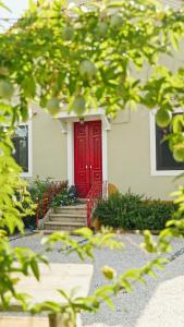 a red front door of a house with stairs at Quinta das Riquezas in Dornes +52 photos