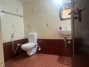 a bathroom with a toilet and a sink at Manasam Homes Near To IIM & NIT - kOZHIKODE in Kunnamangalam +56 photos