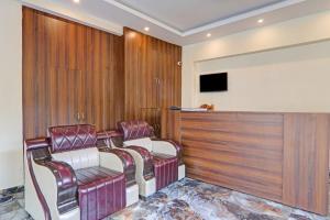a waiting room with two chairs and a tv at Amba heritage house in Prayagraj