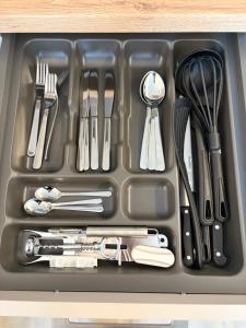 a tray filled with utensils in a drawer at Stäy Gronau in Am Berge +2 photos