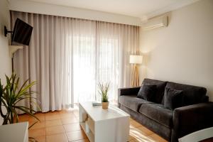 a living room with a couch and a coffee table at Giramar Apartamentos Turisticos in Lagos