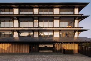 an external view of a building with a large building at Capella Kyoto in Kyoto