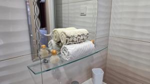 a bathroom with a glass shelf in front of a mirror at ALEKSANDAR - luxury stay private guest rooms in Gotse Delchev +107 photos