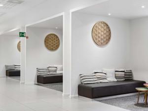 a room with couches and pillows on the wall at Novotel Paris Est Centre de Conférence in Bagnolet