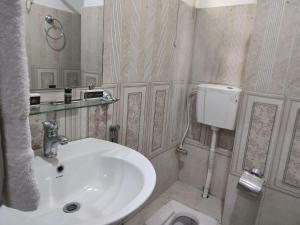 a bathroom with a sink and a toilet at Sapphire Stays Hotel And Restaurant in Peshawar