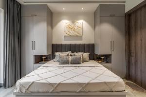 a bedroom with a large bed in a room at Nirvanika Wellness Luxury Apartments in Rishīkesh