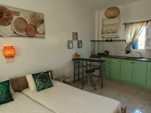 a kitchen with a bed and a table in a room at Sunshine in Maltezana
