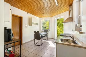 a kitchen with a sink and a table at Ferienwohnung Im Tal Olsberg in Olsberg +13 photos