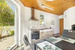 a kitchen with a table and a stove top oven at Ferienwohnung Im Tal Olsberg in Olsberg