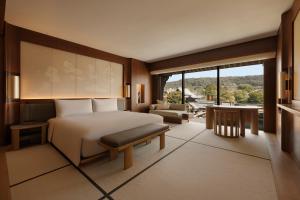 a bedroom with a bed and a large window at Capella Kyoto in Kyoto