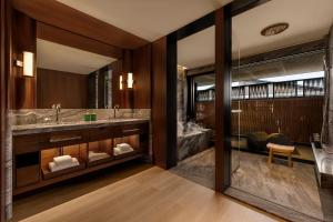 a bathroom with two sinks and a large mirror at Capella Kyoto in Kyoto +37 photos
