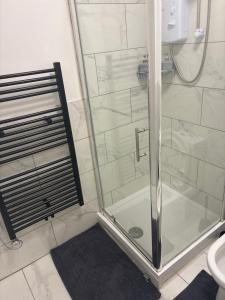 a shower with a glass door in a bathroom at The Parade, Market Square room 3 in Northampton