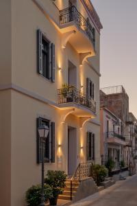 a white building with balconies and a street light at Oikia Classic House in Old Town Kavala in Kavála