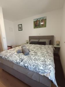 a bedroom with a large bed with blue pillows on it at Sleepover Room K&M in Novoselec
