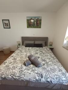 a bed with two pillows on it in a bedroom at Sleepover Room K&M in Novoselec