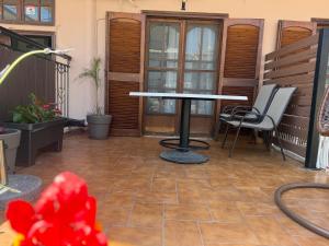 a patio with a table and chairs on a porch at House Mistral in Neos Marmaras +52 photos