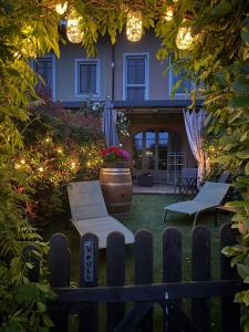 a house with two chairs and a porch with lights at Langhe Wine & Relax in Novello