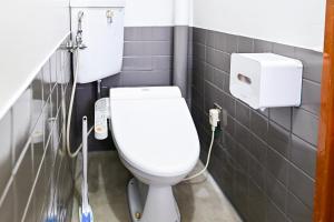 a bathroom with a white toilet in a stall at ブルク井尻 Brug ijiri in Itazuke +26 photos