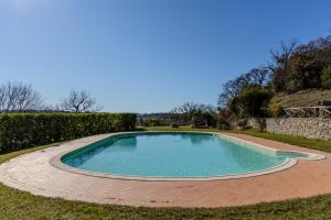 a swimming pool in the middle of a yard at Villa privata in Maremma Tuscany fontanile & wifi in Montorgiali