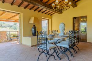a dining room with a table and chairs at Villa privata in Maremma Tuscany fontanile & wifi in Montorgiali