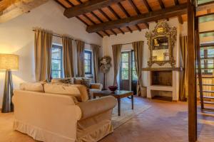 a living room with a couch and a fireplace at Villa privata in Maremma Tuscany fontanile & wifi in Montorgiali