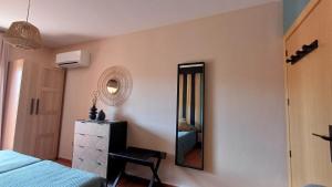 a bedroom with a mirror and a bed and a chair at El Mirador de Adrial in Ladrillar +13 photos