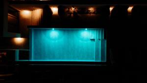 a stage with blue lights in a dark room at MINT Keramoti in Keramoti