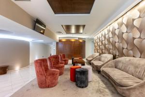 a waiting room with couches chairs and a table at Aston Hotel in Pino Torinese +31 photos