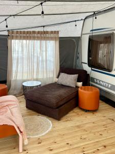 a bed in the middle of a rv at Przyczepa kempingowa PannaMontata in Jastarnia