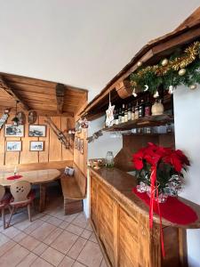 a kitchen with a counter and a table with a christmas decoration at Hotel Garni Relax in Fai della Paganella