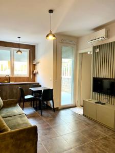 a living room with a couch and a table at Beach Studio Apartment in Dhërmi