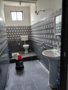 a bathroom with a toilet and a sink at Homestay in Tezpur +25 photos