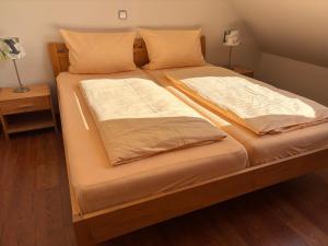 a bed with two sheets and pillows on it at Pension Altes Posthaus in Dangast +34 photos