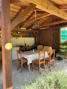 a dining table and chairs in a pavilion at Chalupa Něža in Petrovice +36 photos