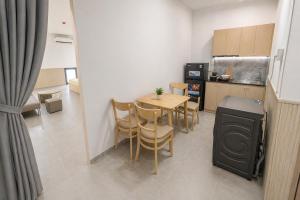 a kitchen and dining room with a table and chairs at Lemon Hotel & Apartment in Danang