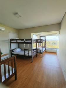 a room with two bunk beds and a large window at The LakeFront Villa in Binangonan +22 photos