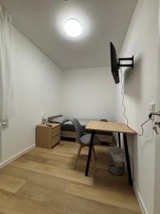 a small room with a desk and a bed at AG Wohnung Fellbach Nr 3 in Fellbach +14 photos