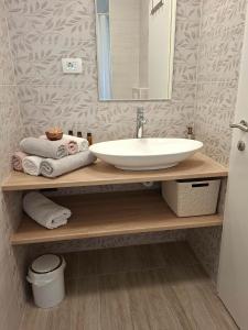 a bathroom with a sink and a mirror and towels at Lavanda & limone in Koper +23 photos