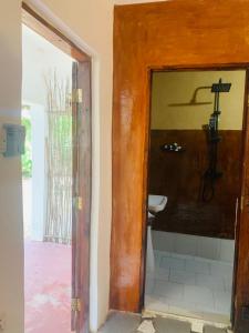 a bathroom with a sink and a toilet in a room at Paje lounge in Paje +217 photos