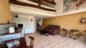 a living room with a couch and a table at Gîte La Thibaud in Lavernat