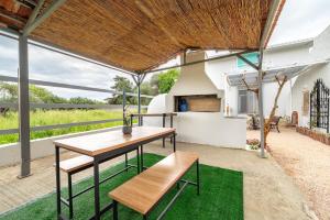 a patio with a wooden table and a bench at Angel House in Ialysos