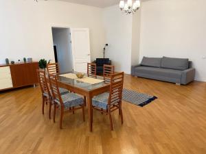 a living room with a table and chairs and a couch at Spacious 2 bedroom apartment, Old Town Riga in Riga +1 photo