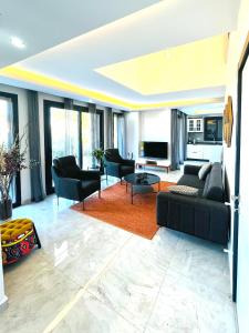 a living room with a couch and chairs and a table at Premium Homes in Didim