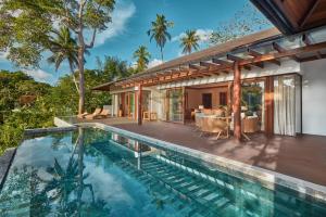 an external view of a house with a swimming pool at The Farm at San Benito, Autograph Collection in Lipa