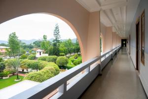 an empty corridor in a building with an archway at Hotel Imphal by the Classic in Imphal