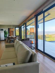 a living room with a couch and a table at The LakeFront Villa in Binangonan