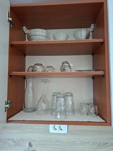 a cabinet filled with glasses and other glass items at Lavanda & limone in Koper