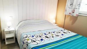 a bed with a bunch of shoes on it at ZEcamping 2 avec piscine restaurant vue sur le village de Saint Auban in Briançonnet +48 photos