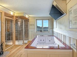 a large bathroom with a tub and a window at Admiral Stuuv in Barth